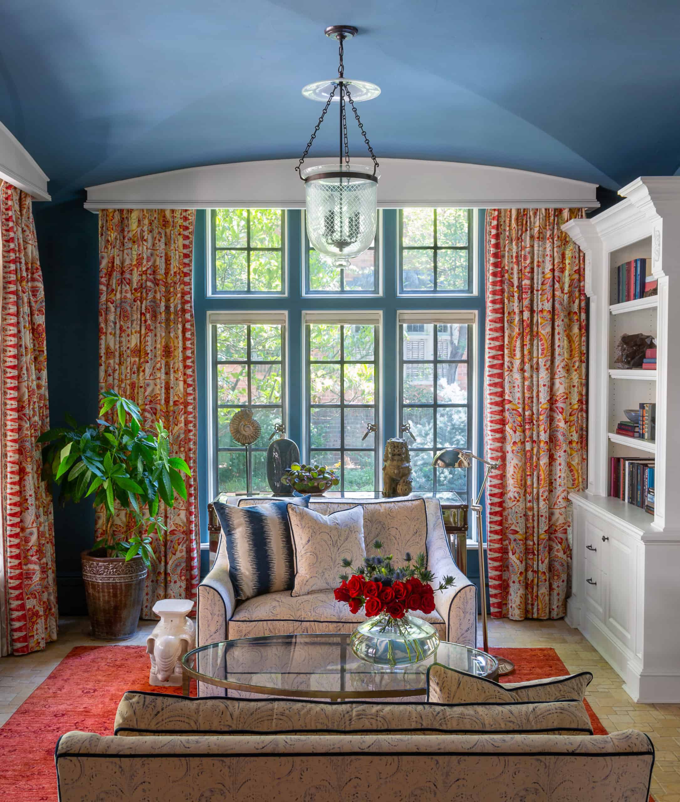 Decorating with patterned draperies, paisley chair and a half chairs and a blue ceiling
