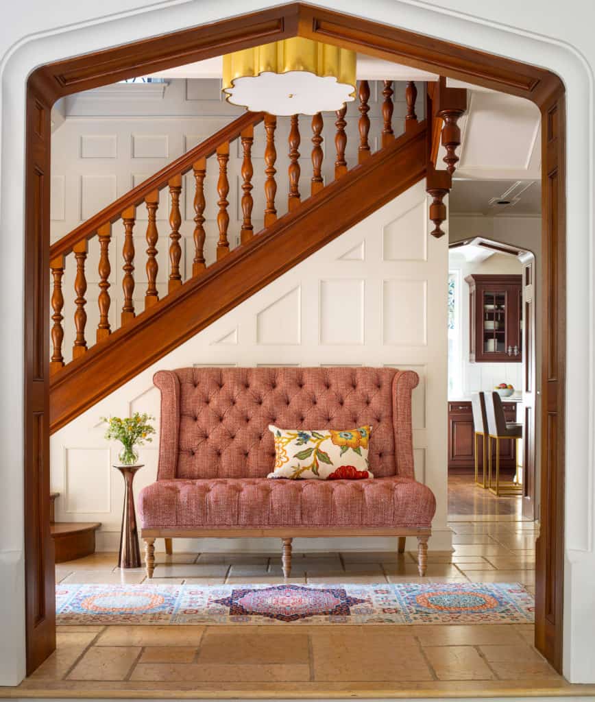 Elegant inviting entryway with bench in complete home interior remodel. tudor home renovation