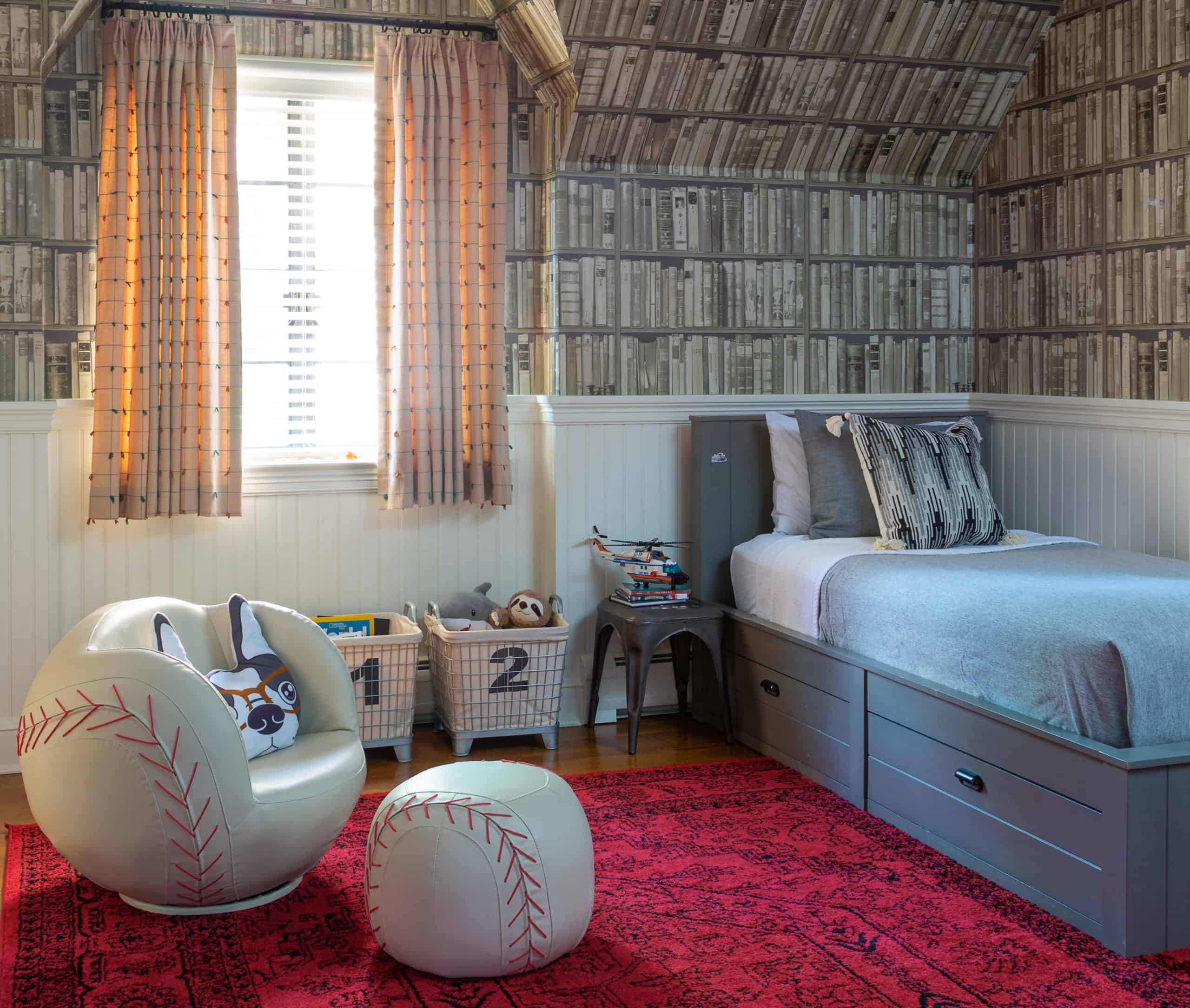 Fun boys room decorated with baseball chair and bookshelf wallpaper