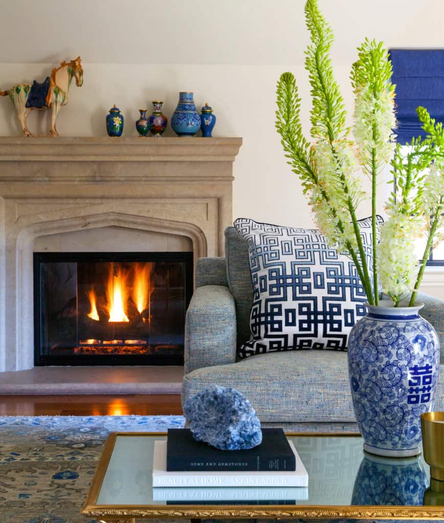 Bedroom sitting area with stone fireplace mantle