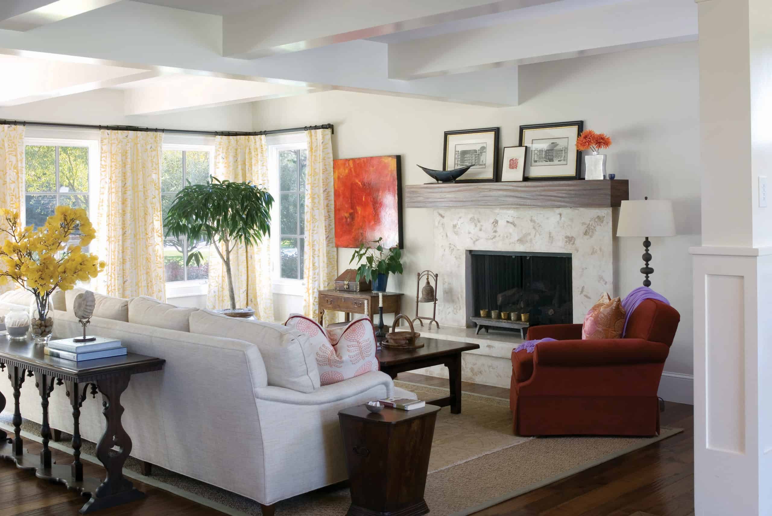 Redesigned family room with bright windows and modern wood burning fireplace in Renovation Remodel