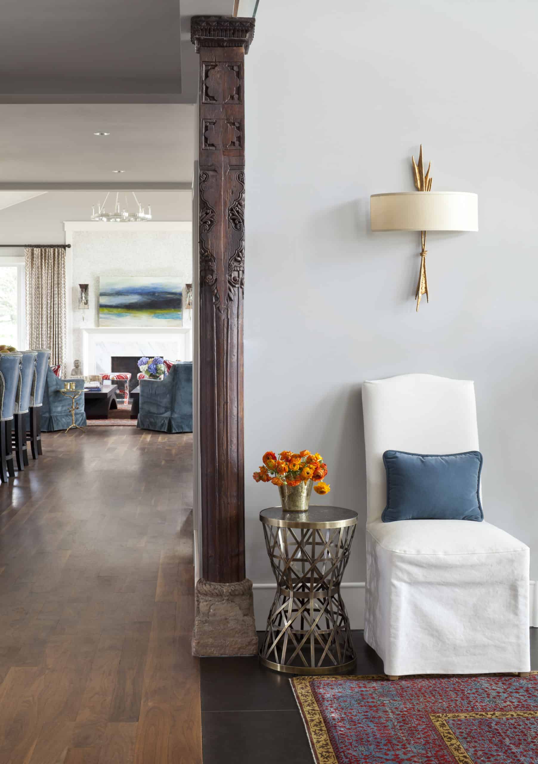 Simple home entry decor with sconce and antique door column