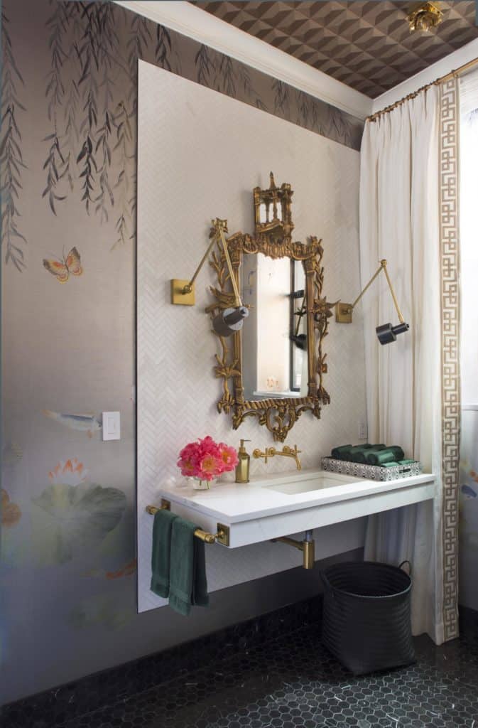 Lavish bathroom with ornate mirror, custom Asian style wallcovering and herringbone tile
