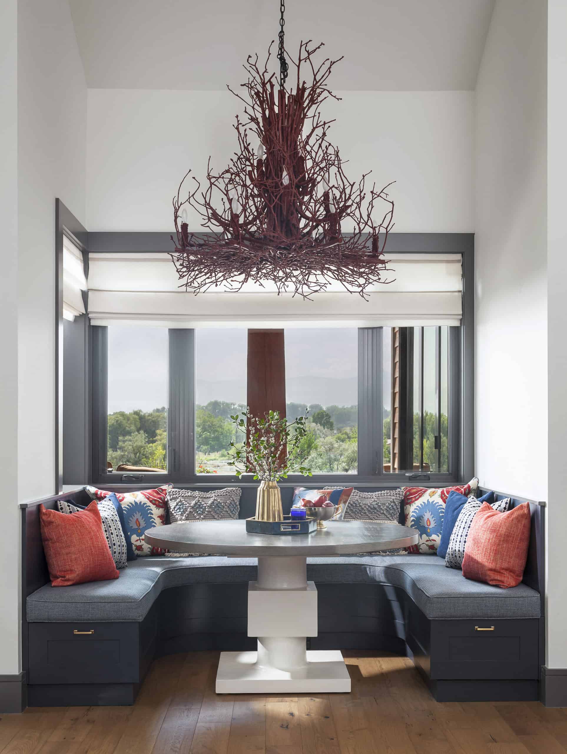 Built-in benches and creative branch twig chandelier in breakfast nook