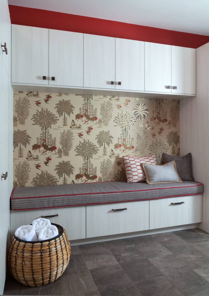 Mudroom with built-in cabinets and bird wallpaper in Rustic Reimagined home