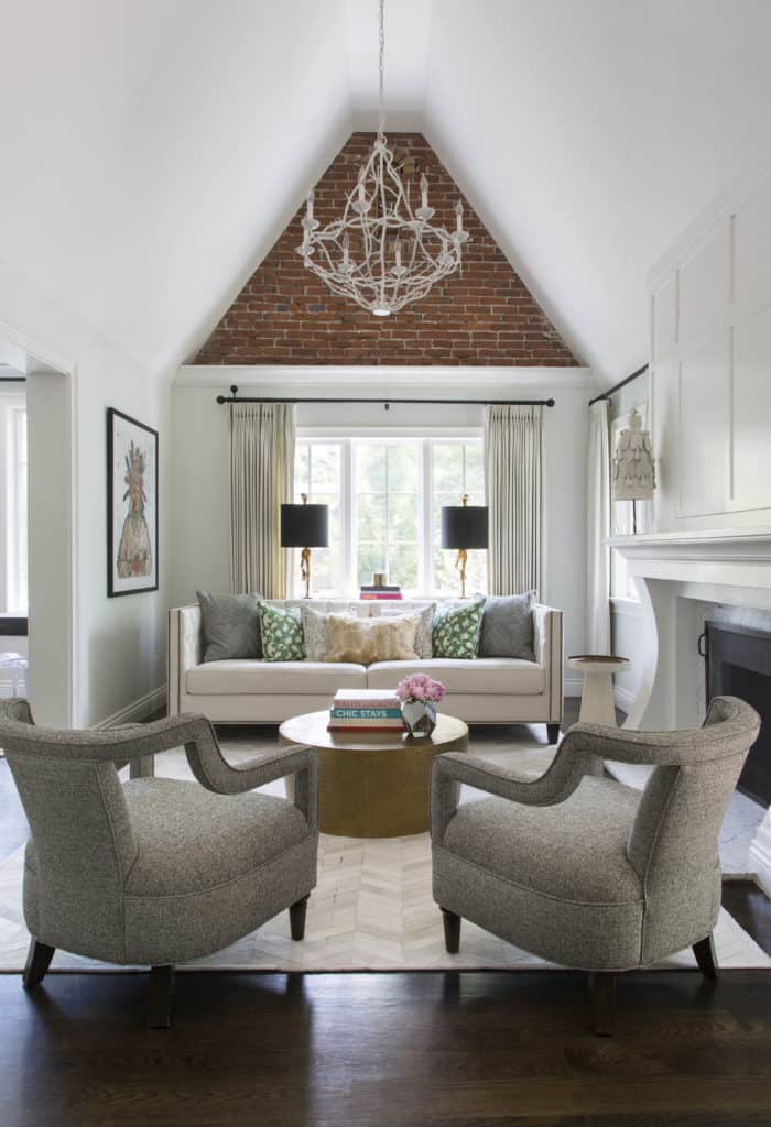 Upscale family room furnishings by interior designer Denver with exposed brick
