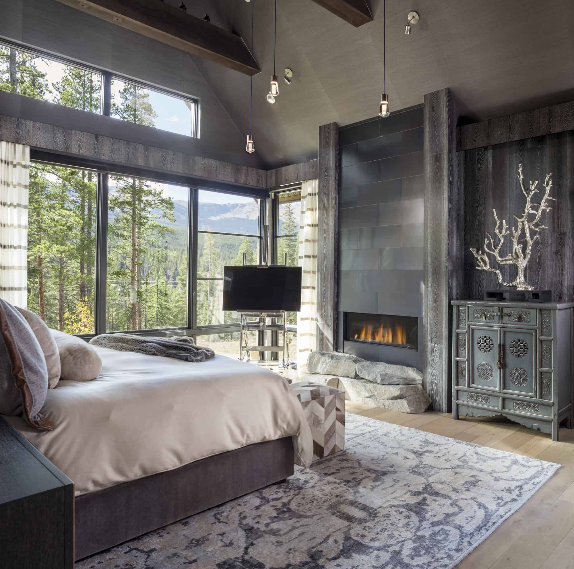 Gorgeous fireplace in moody master bedroom colorado interior design