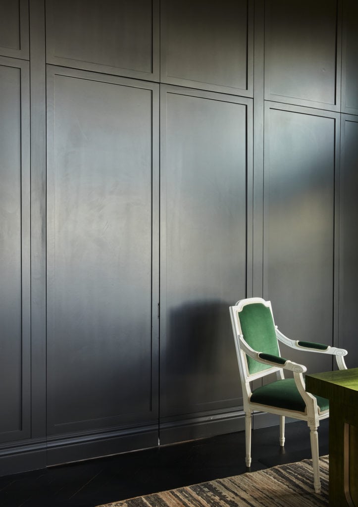 Sleek dark walls with colorful chair by interior designer in denver colorado