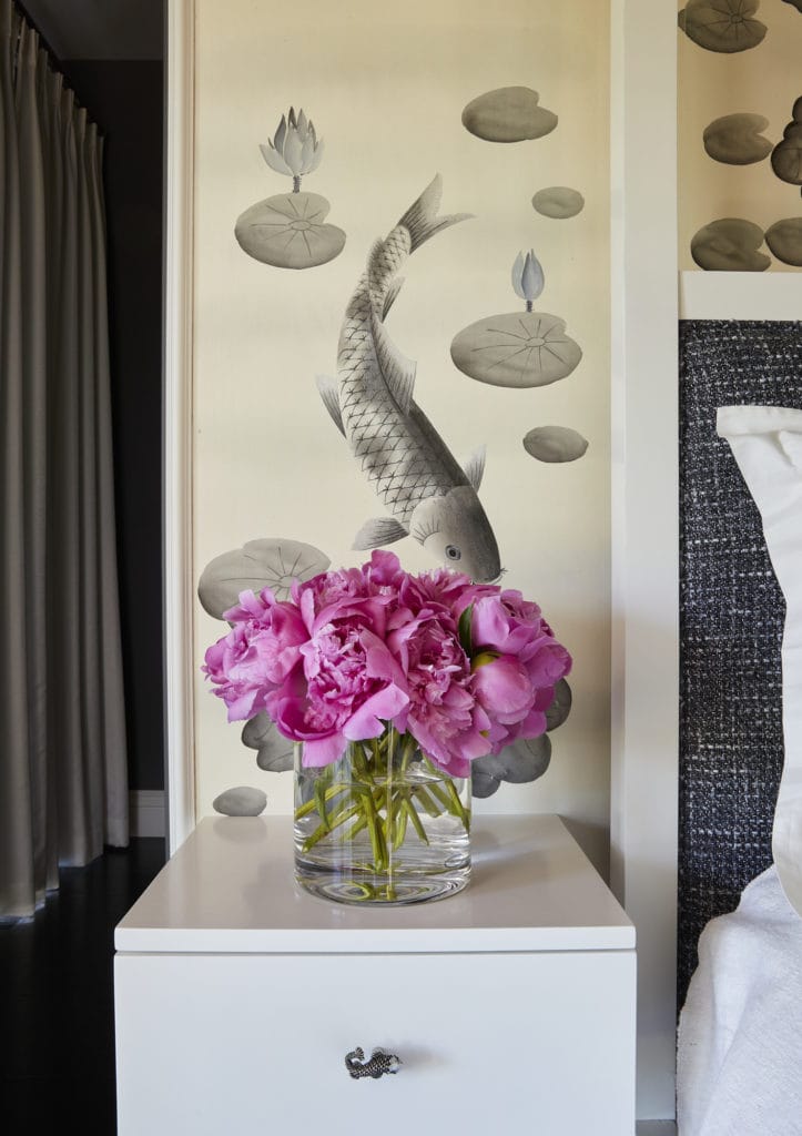 Bedroom with koi pond wallpaper and nightstand with unique pulls