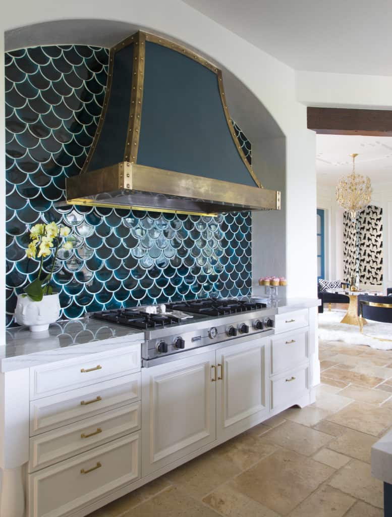 Custom kitchen design with metal hood and blue green shell backsplash by best Denver interior designer