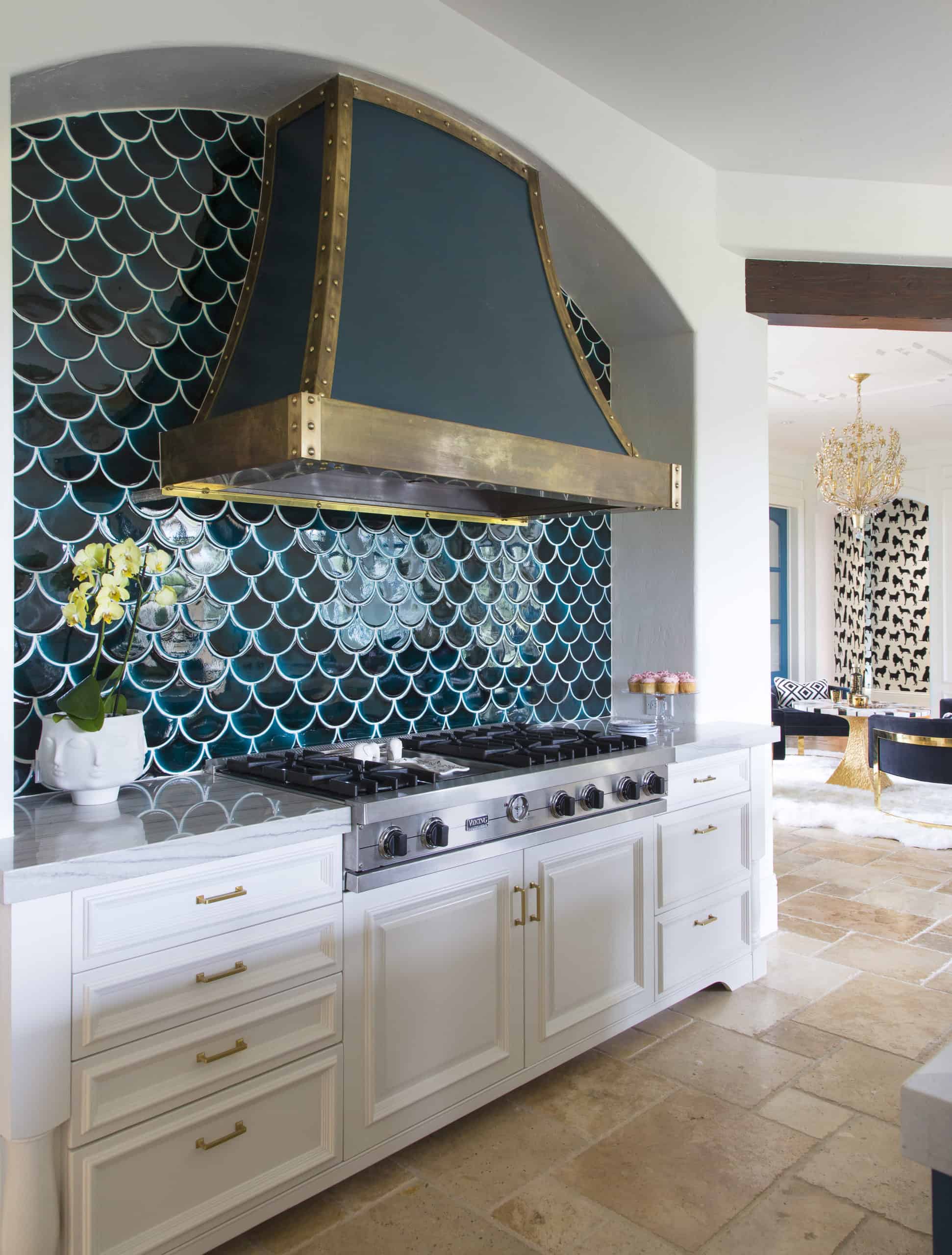 Custom kitchen design with metal hood and blue green shell backsplash by best Denver interior designer