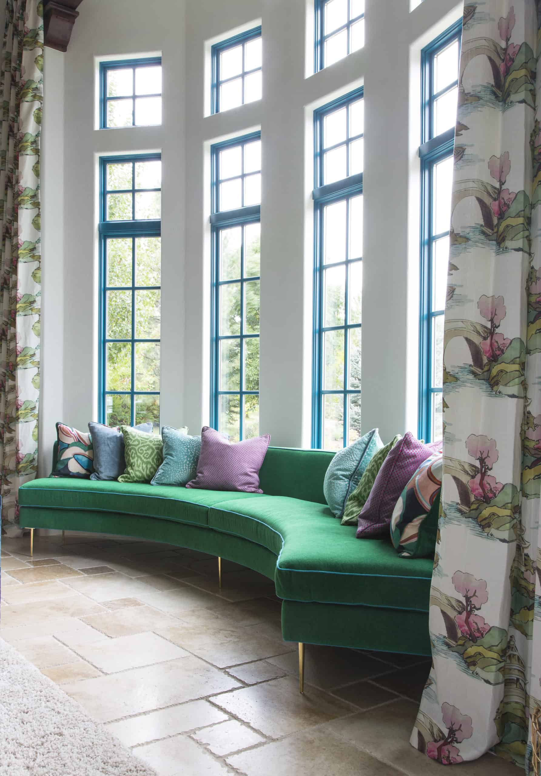 Large custom curved green sofa in bay window