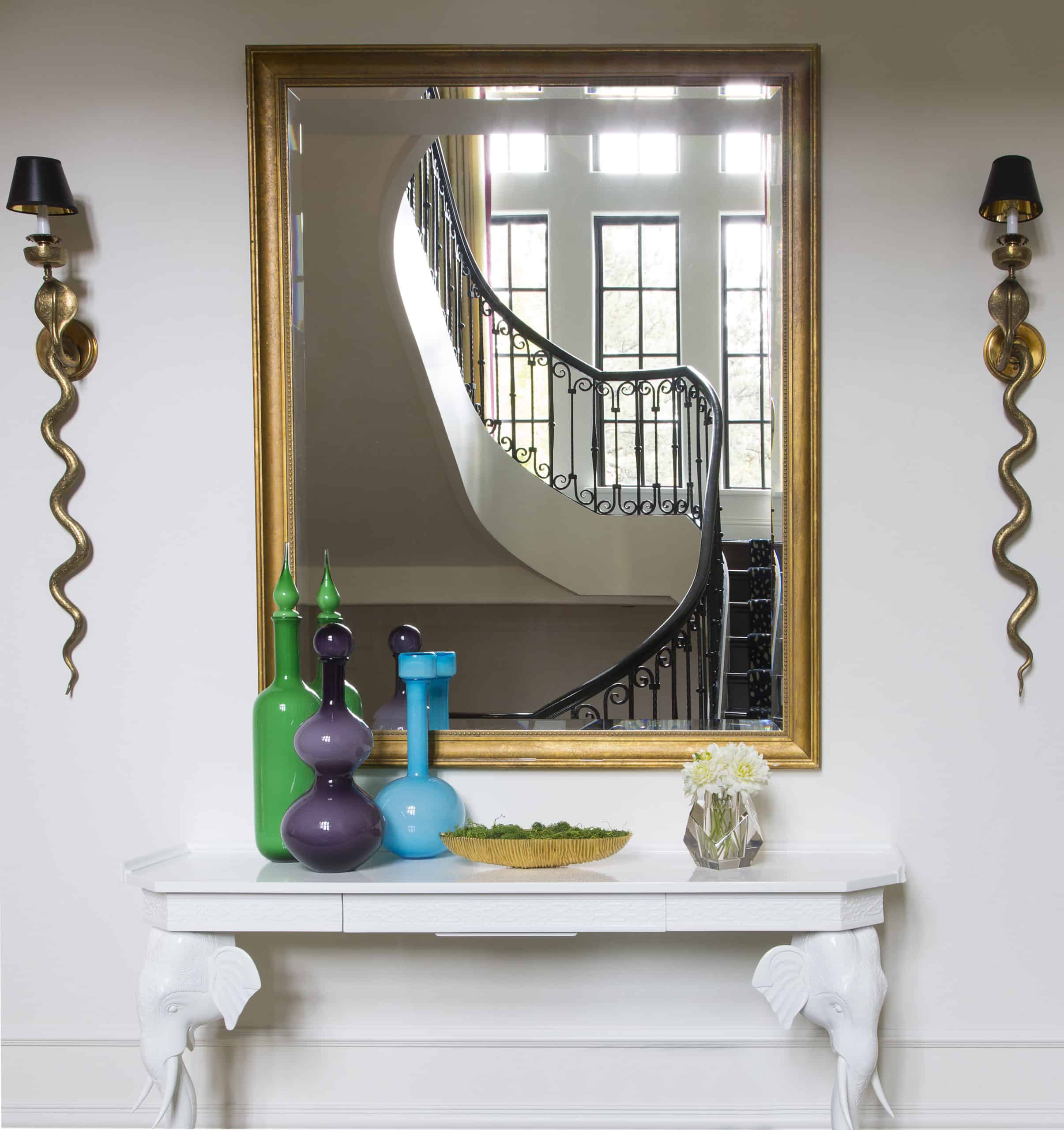 Fantastic home decor in entry with elephant console table and snake sconces