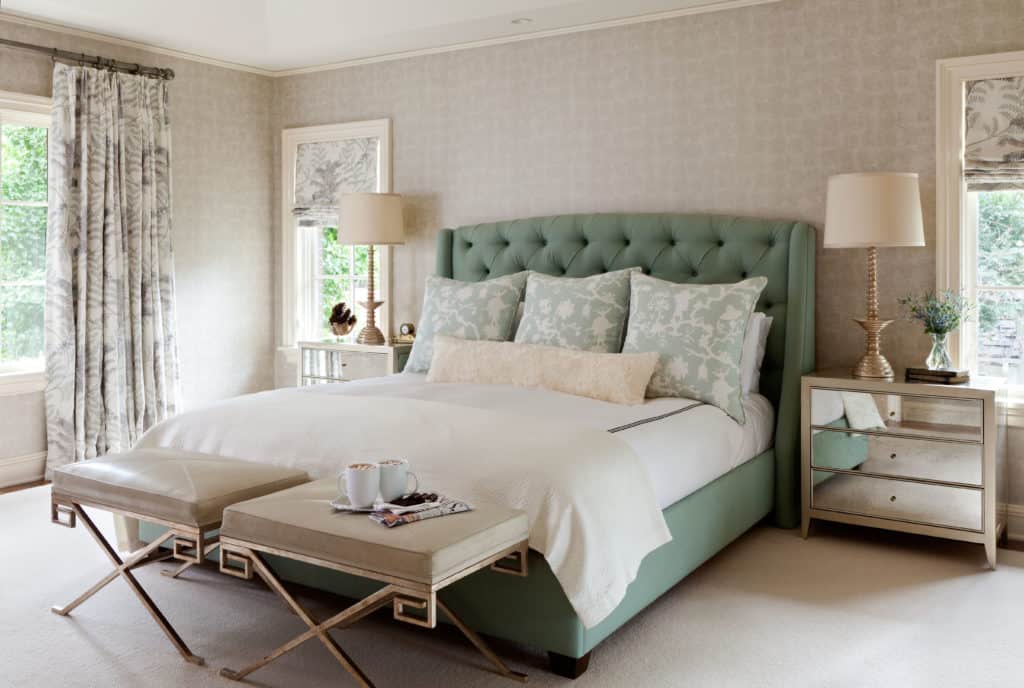 Bedroom with seafoam green custom bed, metal nightstands and calming tones