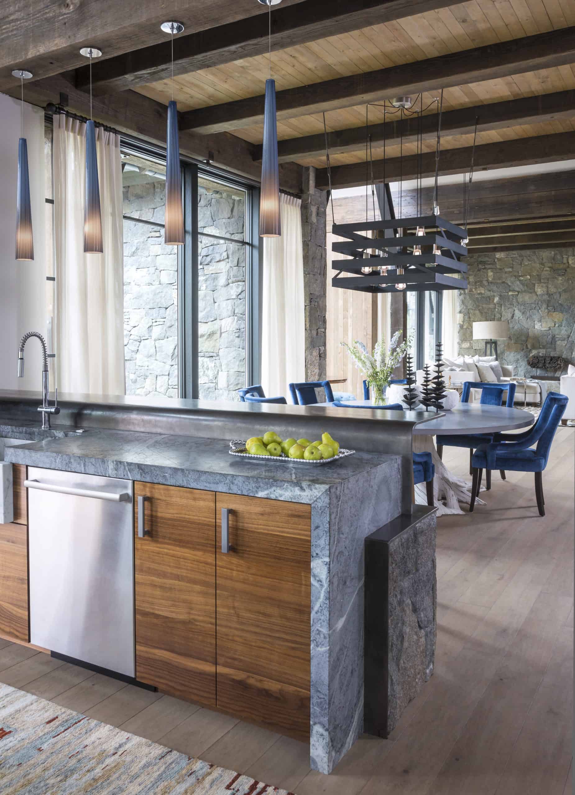 Wooden beamed ceiling and stone waterfall countertops colorado home design