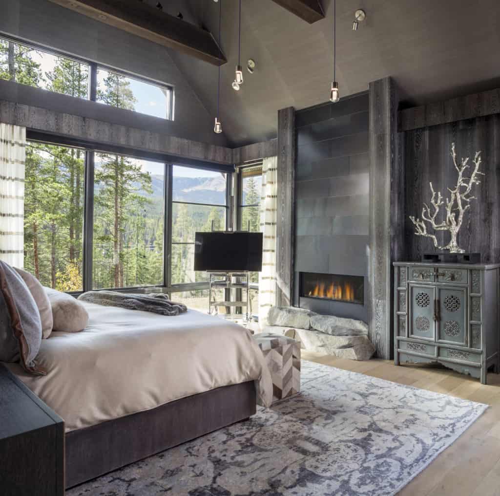 Colorado mountain modern interior design bedroom with fireplace