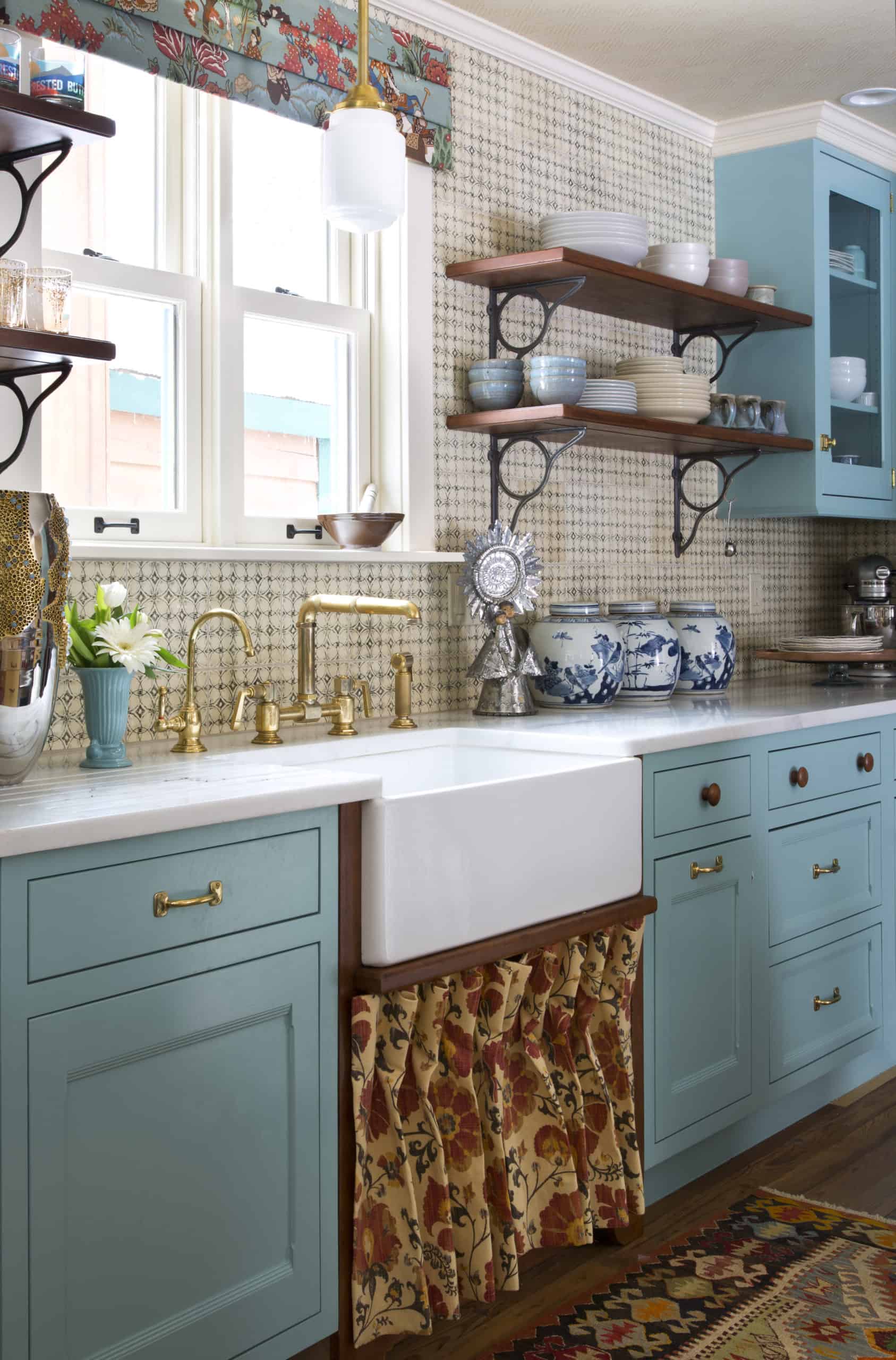 Farmhouse sink in country kitchen with light blue turquoise cabinets