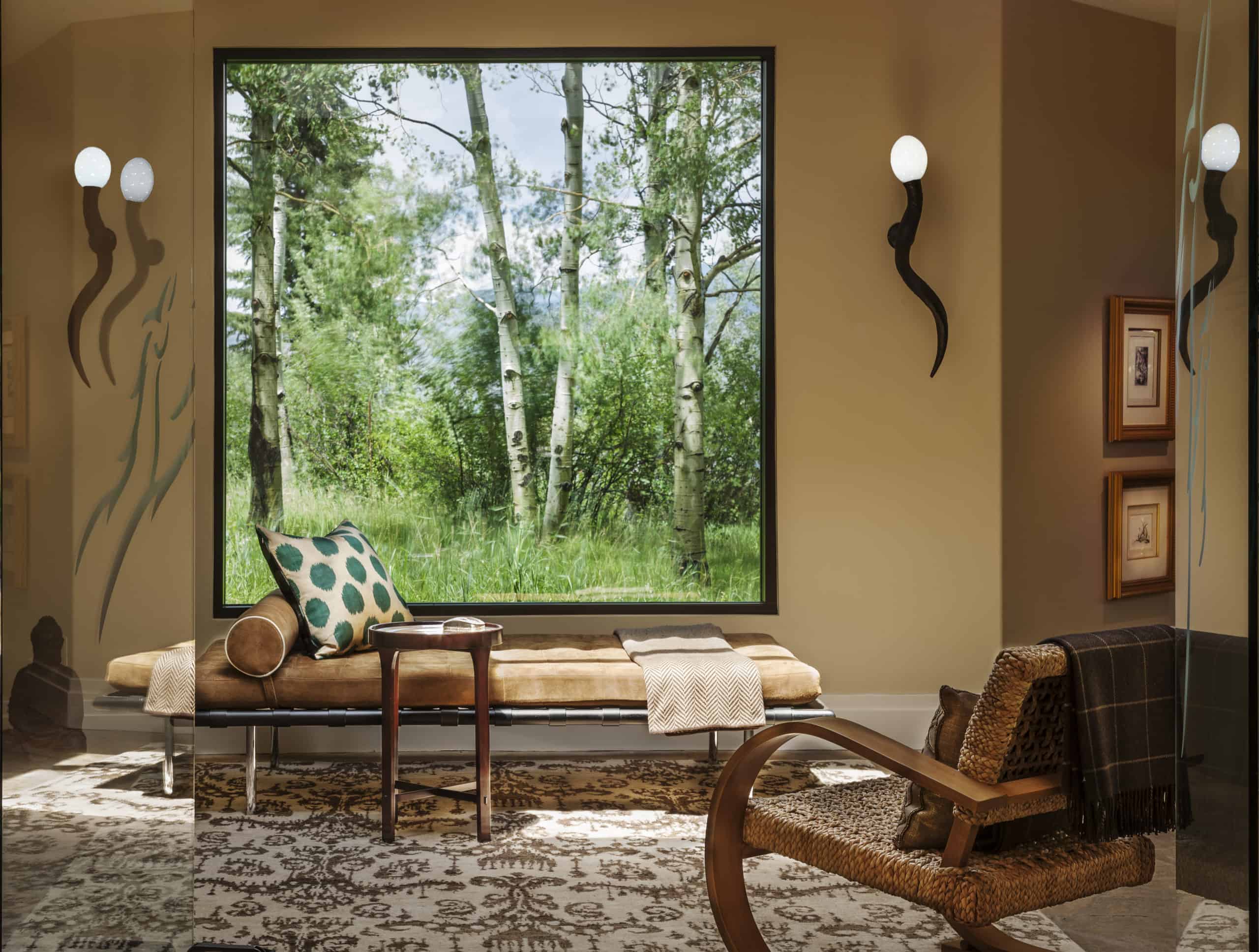 Picture window decor with custom bench and unique sconces
