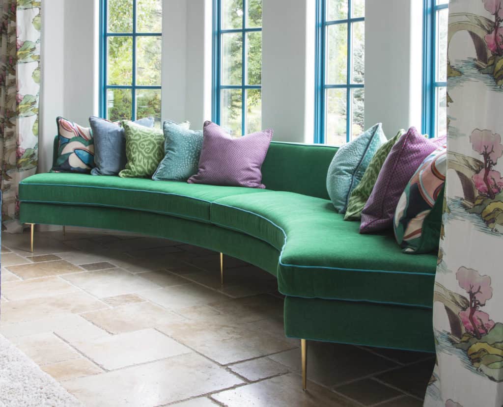 Curved green sofa and furnishing colors that evoke emotion