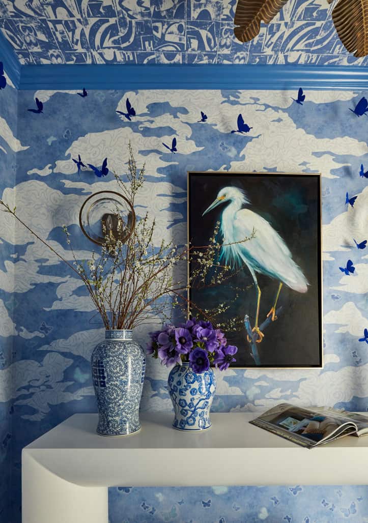 detail image of powder foyer with blue wallpaper and blue butterfly art
