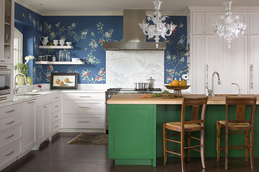A bright green kitchen island ads vibrance to any kitchen. Contrasting with the blue floral wallpaper, this color pairing brings the outdoors in.