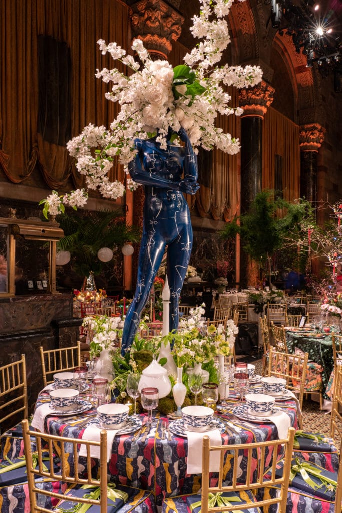 tablescape with a blue mannequin with a flower headress