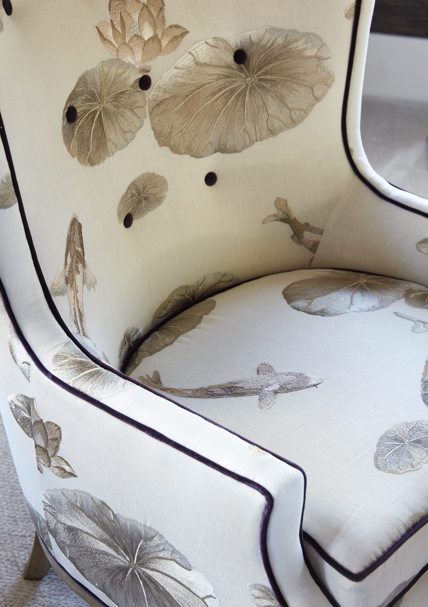 neutral upholstered chair with piping and unique fabric