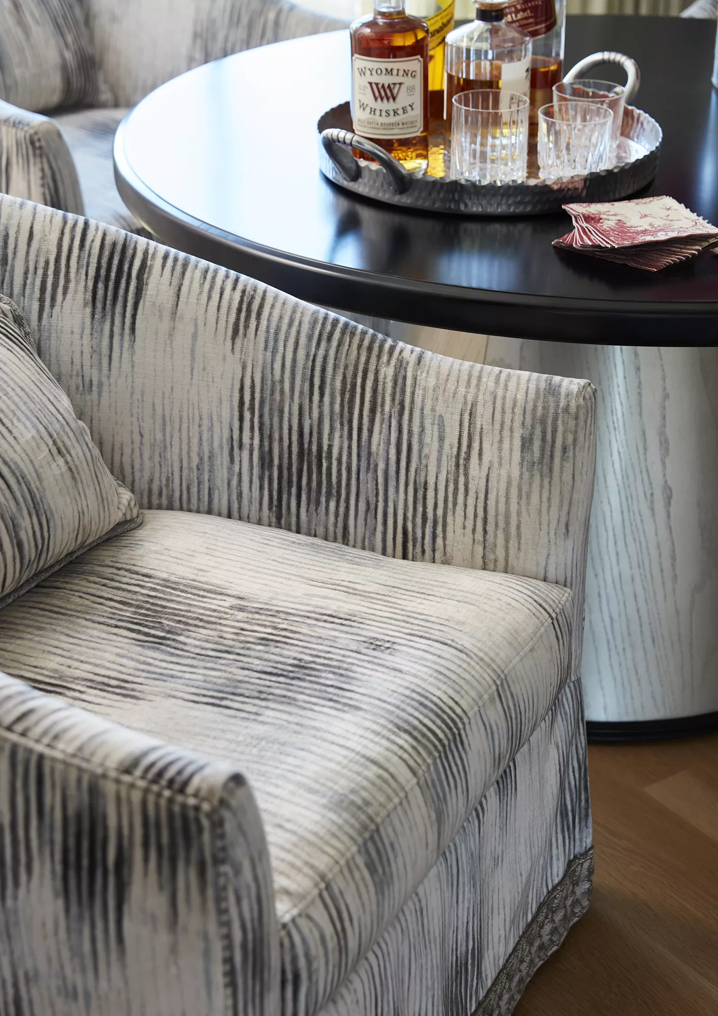 black and white upholstered chairs with metallic tea table