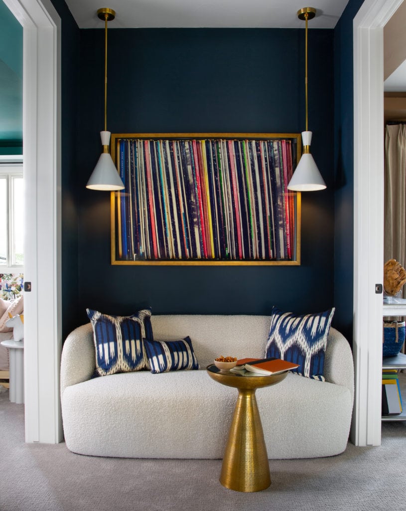 Seating area within a hallway with blue walls.