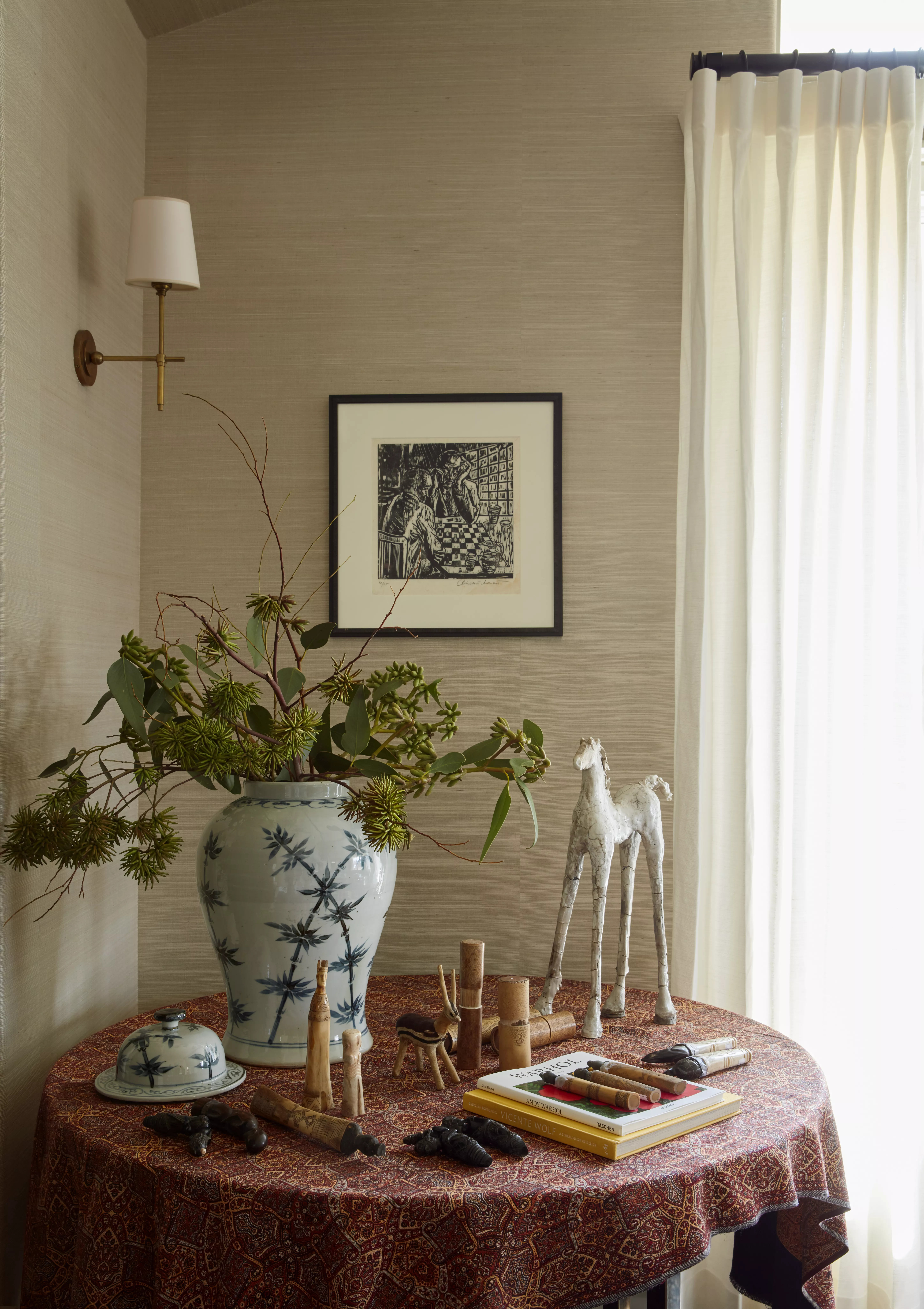Home display table lit by wall sconce
