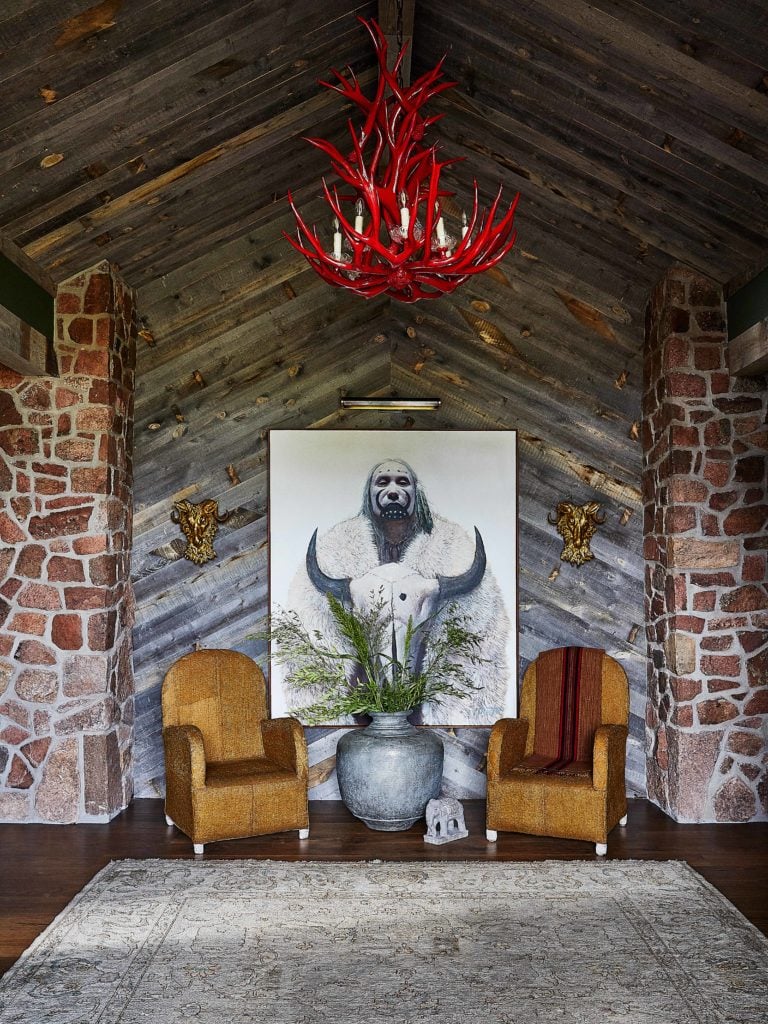 Rustic ranch entry with red lacquered antler chandelier in Modern Ranch Interior Design