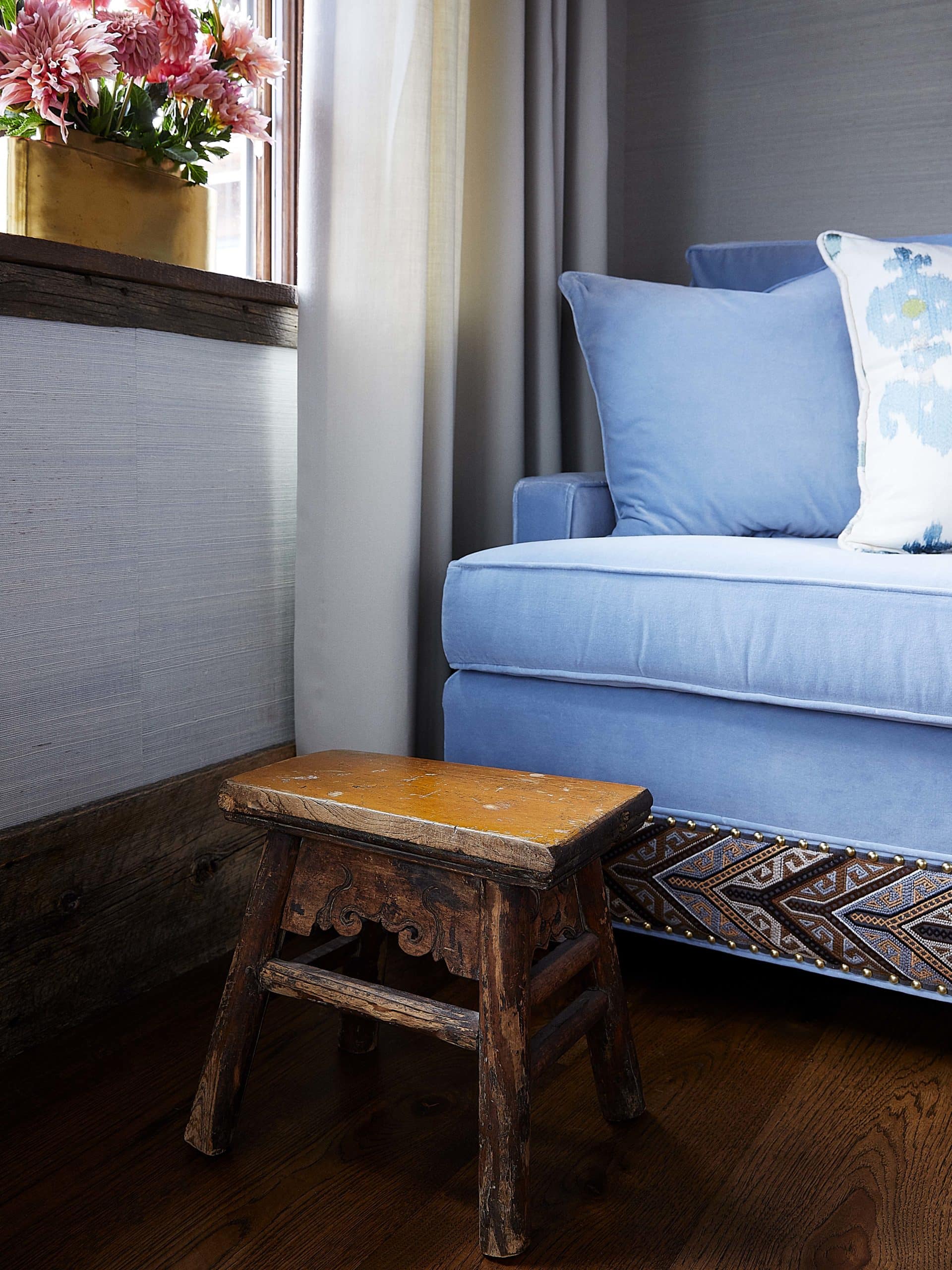 Baby blue velvet sofa and antique foot stool by colorado interior design firm