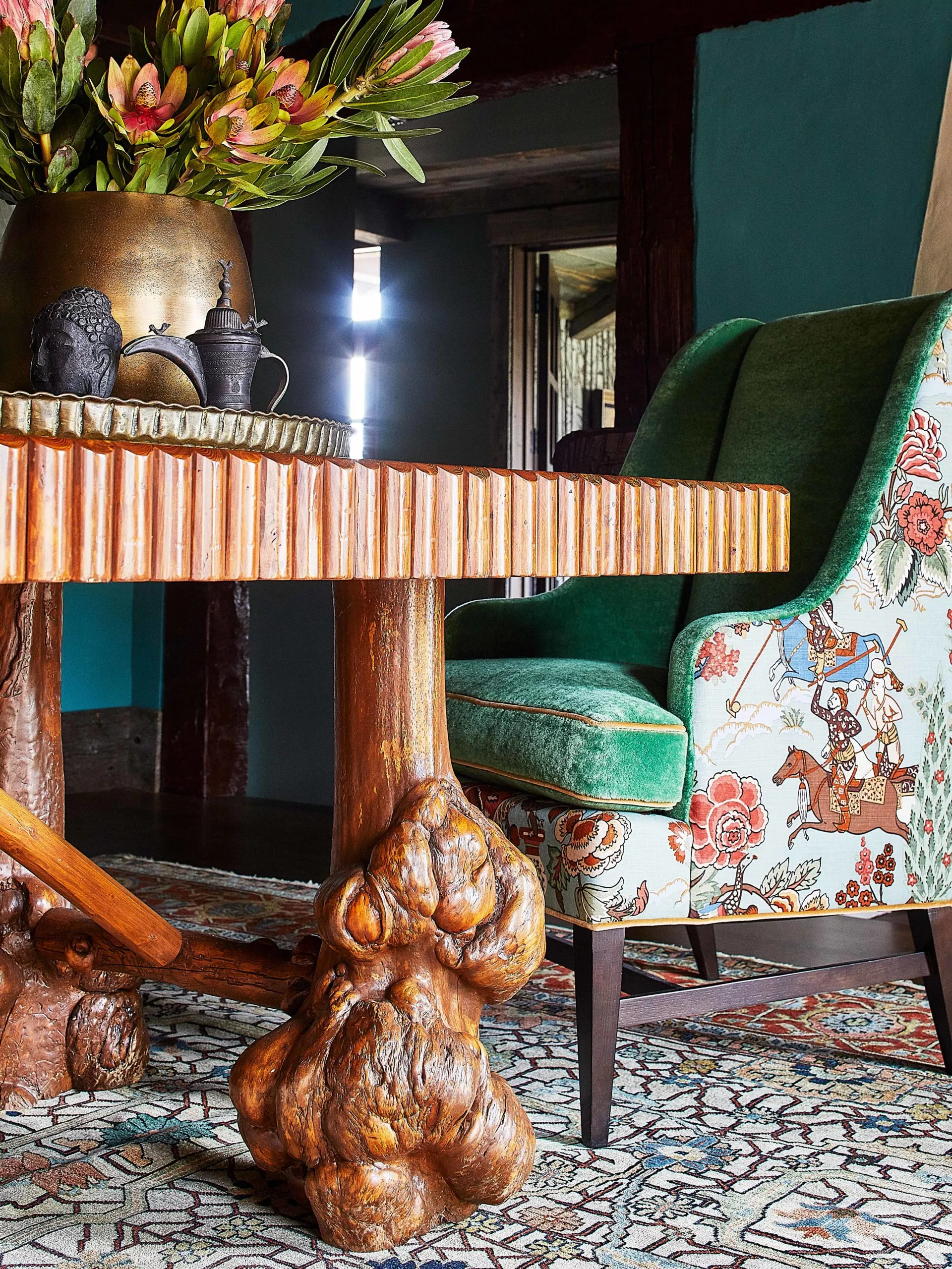 Unique wooden dining table with custom dining chairs covered in polo print fabric.