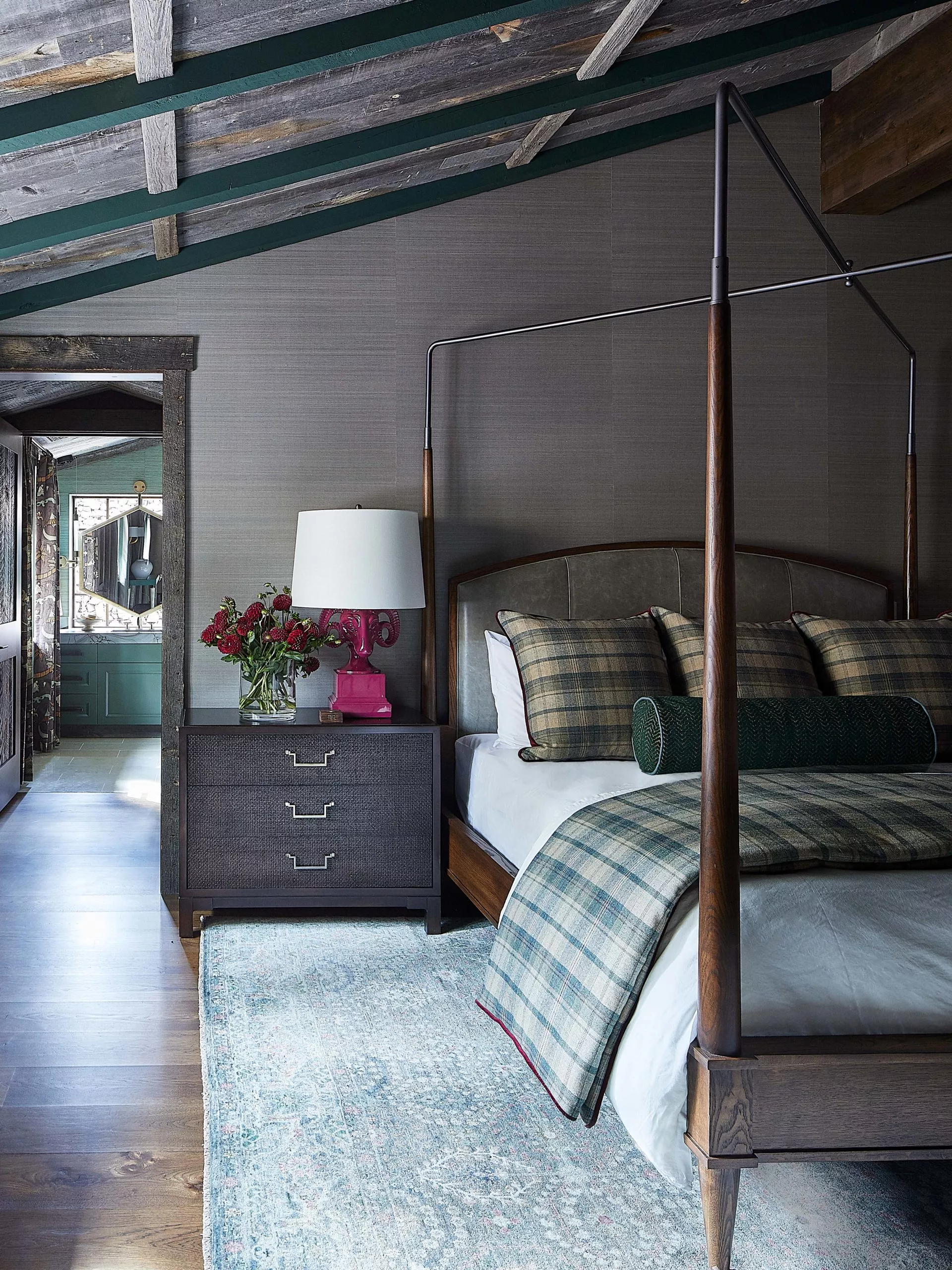 Rustic bedroom with plaid and green accents, hot pink lacquered rams head lamp.
