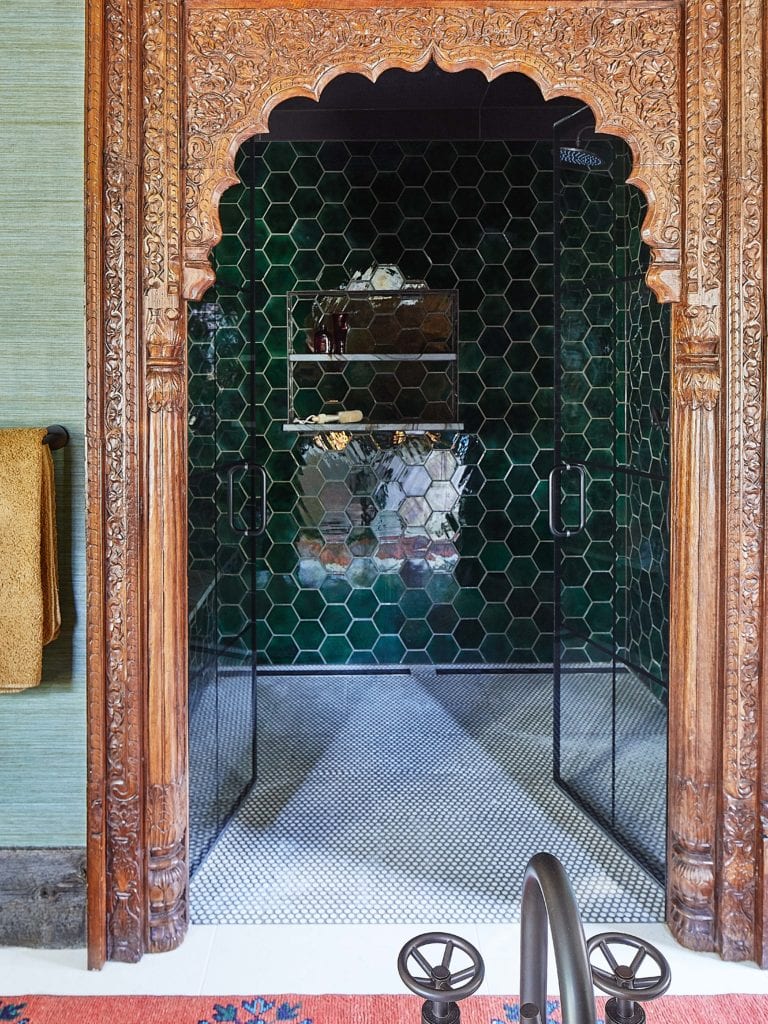 Eclectic steam shower with green hexagonal tile with antique Indian archway
