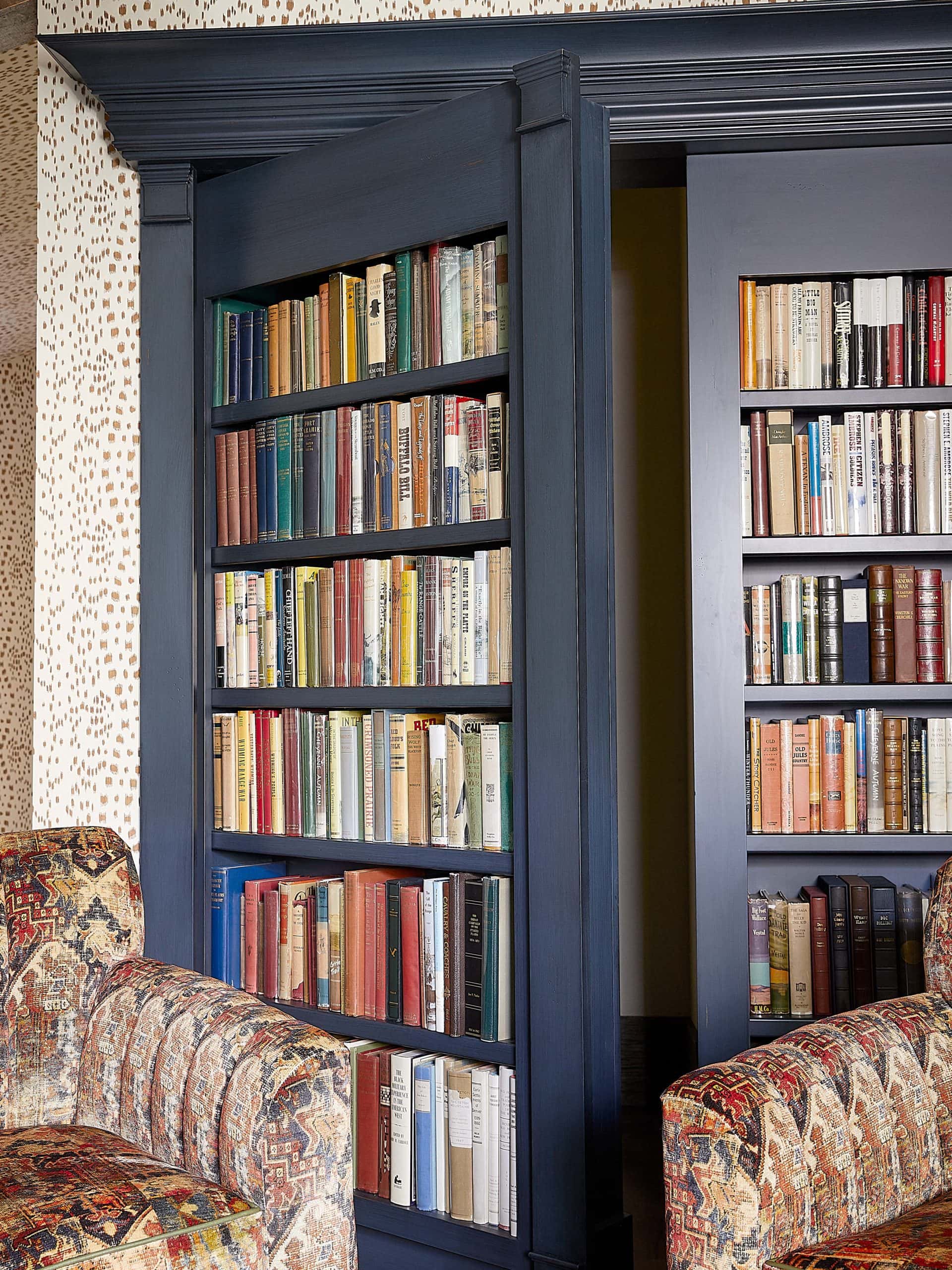 Cozy library study with hidden jib door bookshelf.