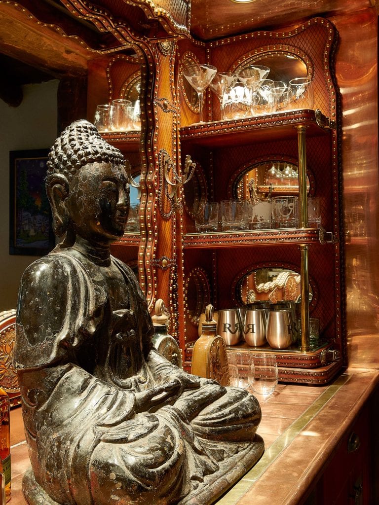 In-home copper bar with an antique buddha.