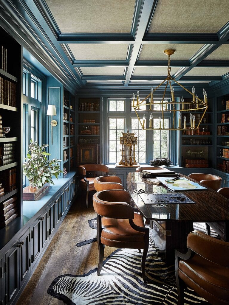 Eclectic interior architecture library with blue built ins and zebra rug