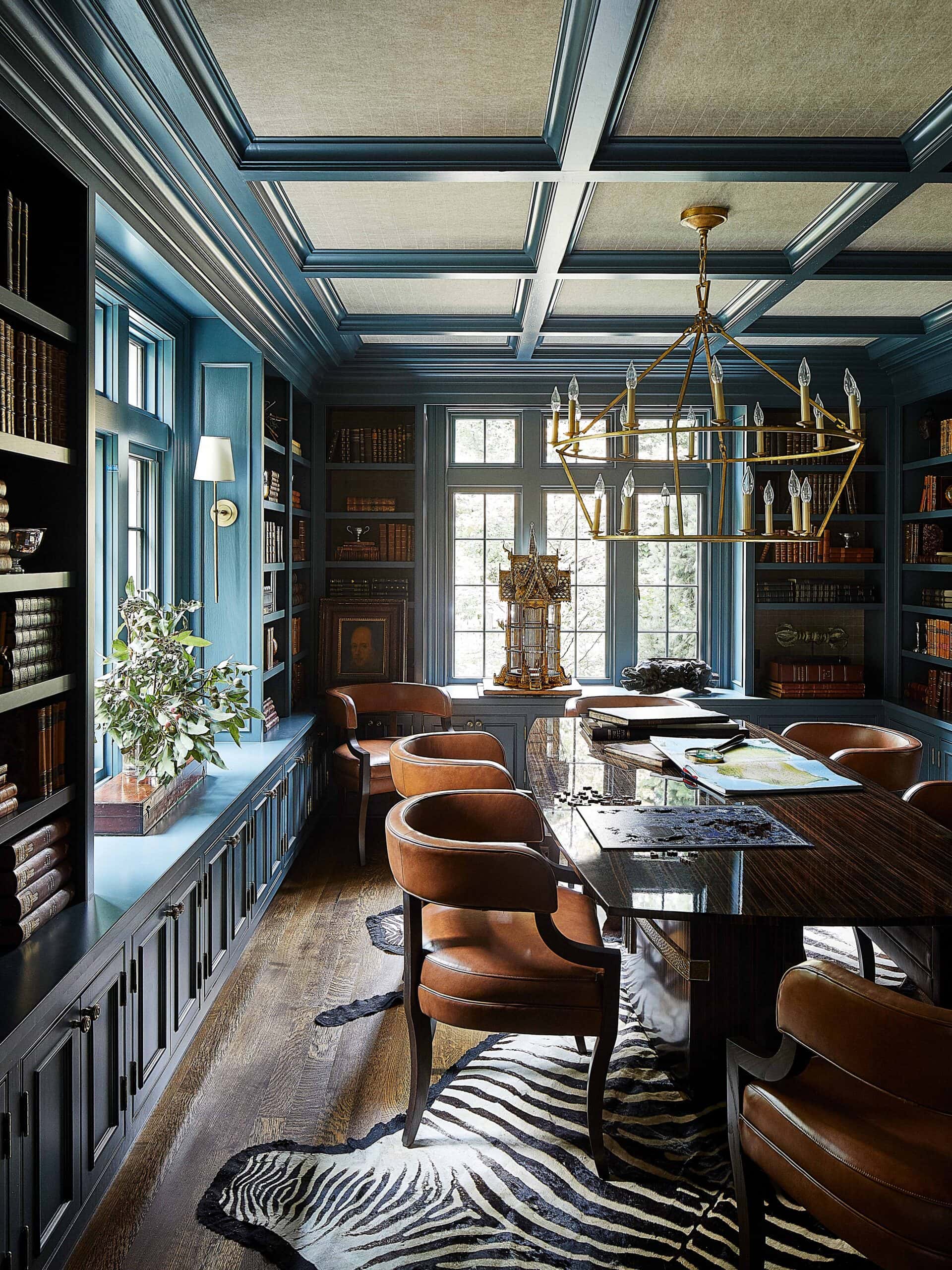 Modern Eclectic Interior Design library with blue built ins and zebra rug