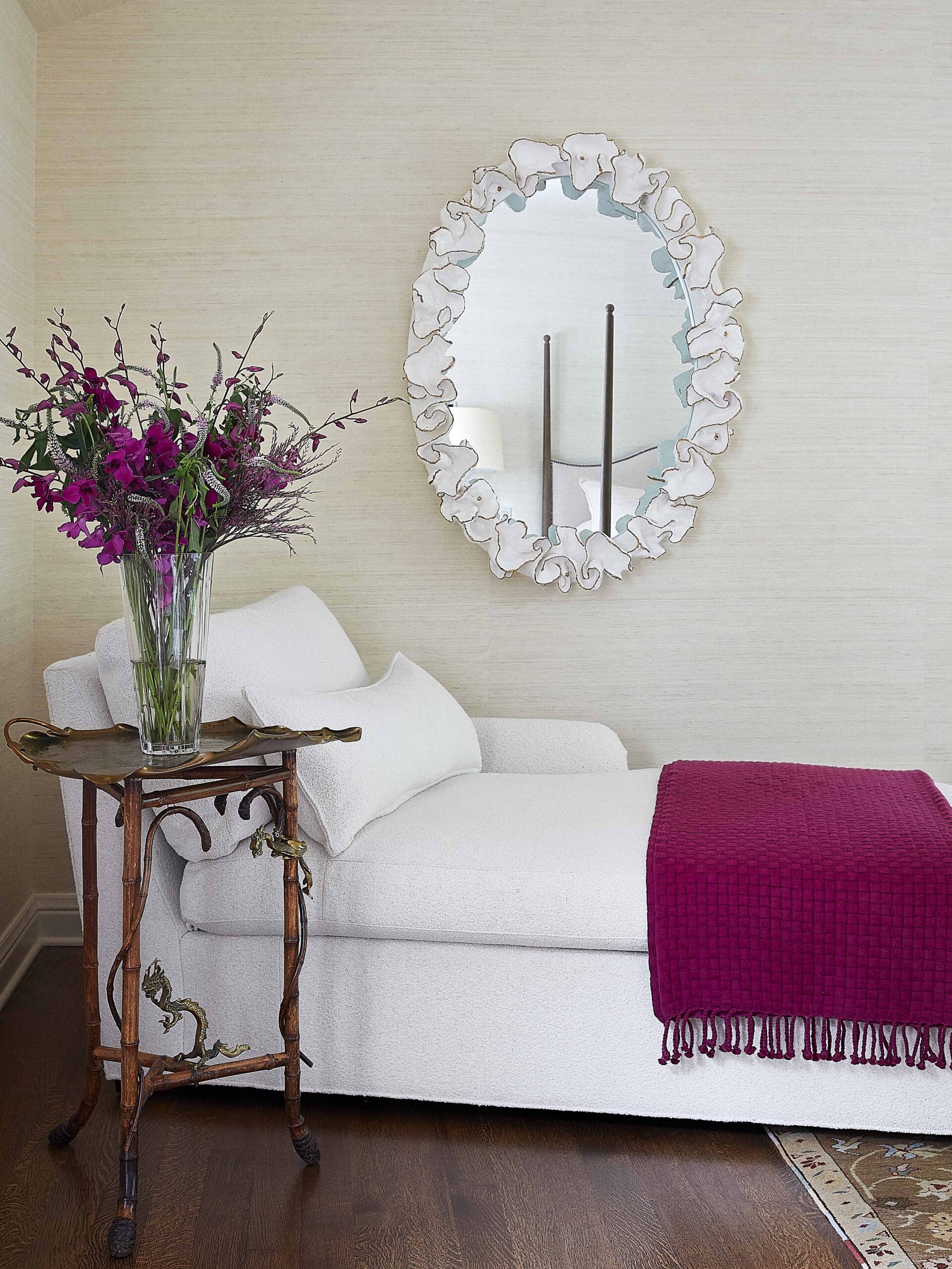 Chaise lounge area in bedroom with ruffled mirror design