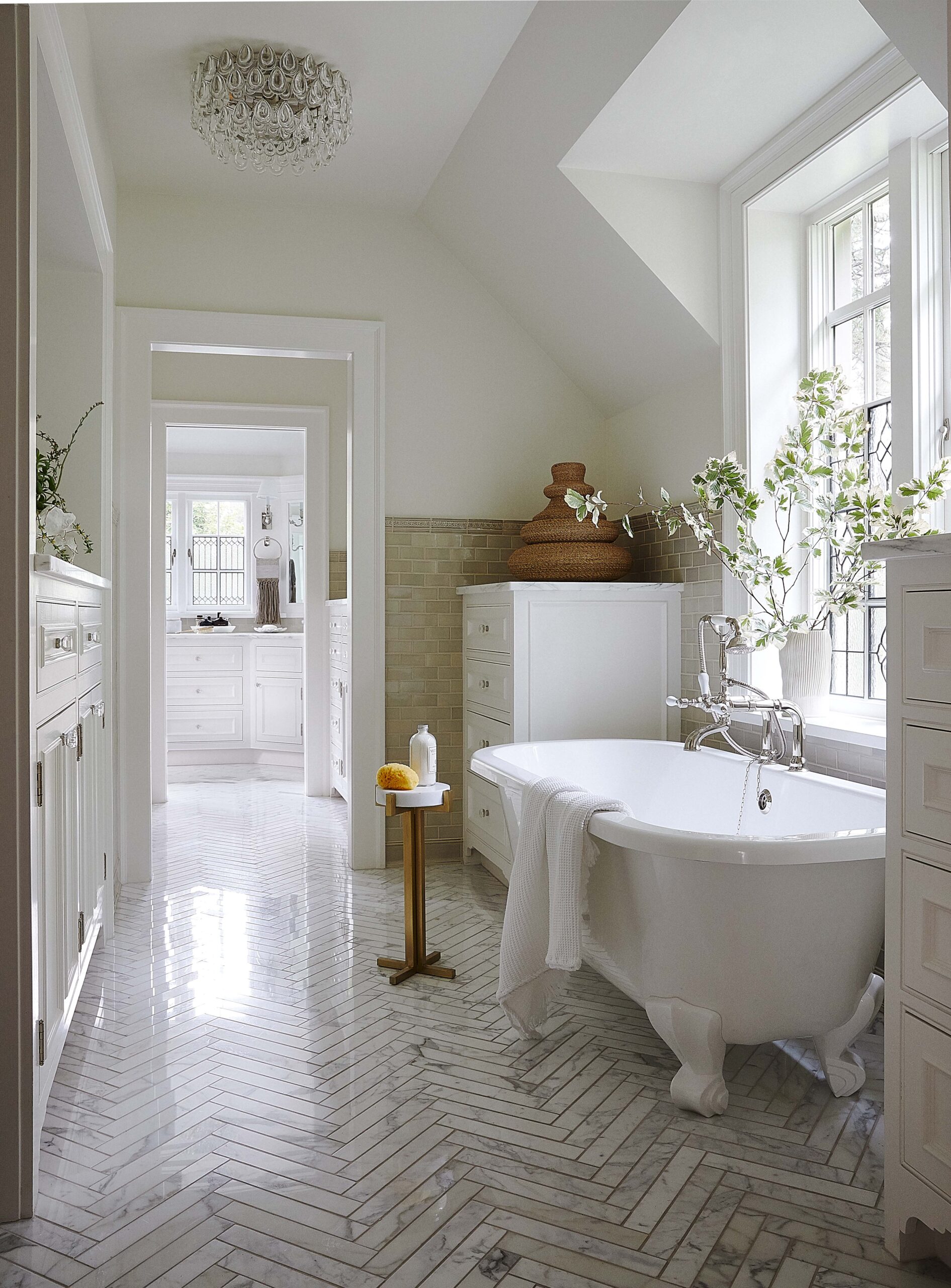serene neutral bathroom design with a clawfoot tub and marble