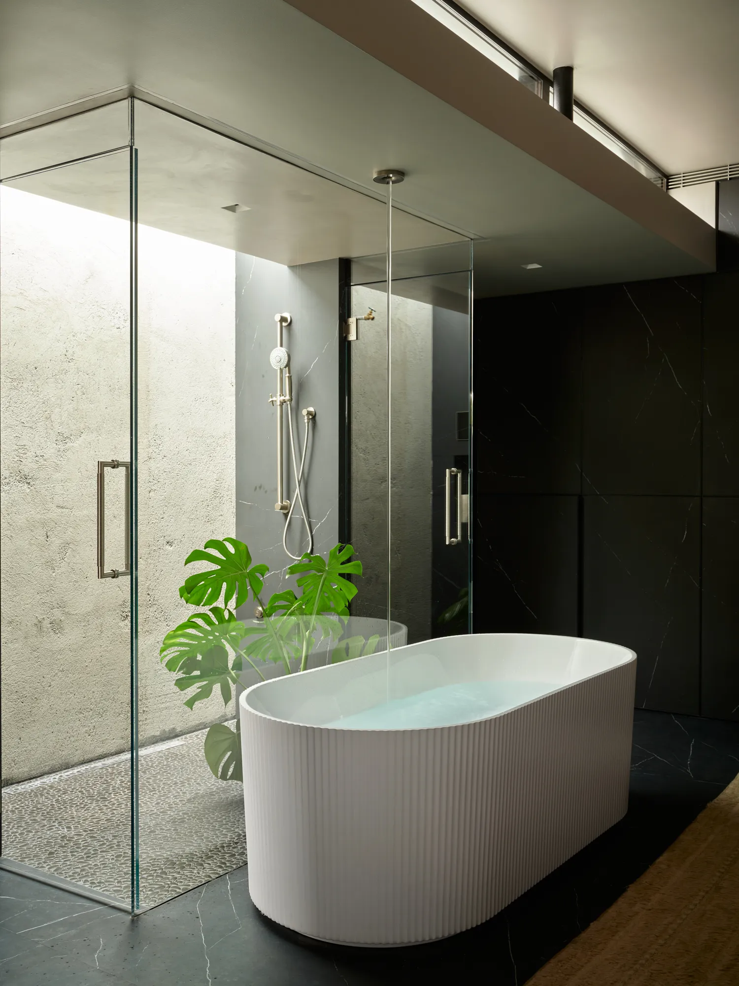 Minimalist spa bathroom with freestanding tub and walk in shower