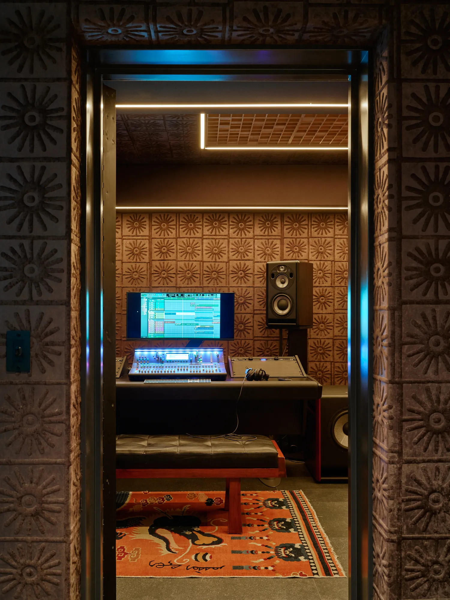 Custom listening room with warm wood detailing and integrated lighting in California luxury home